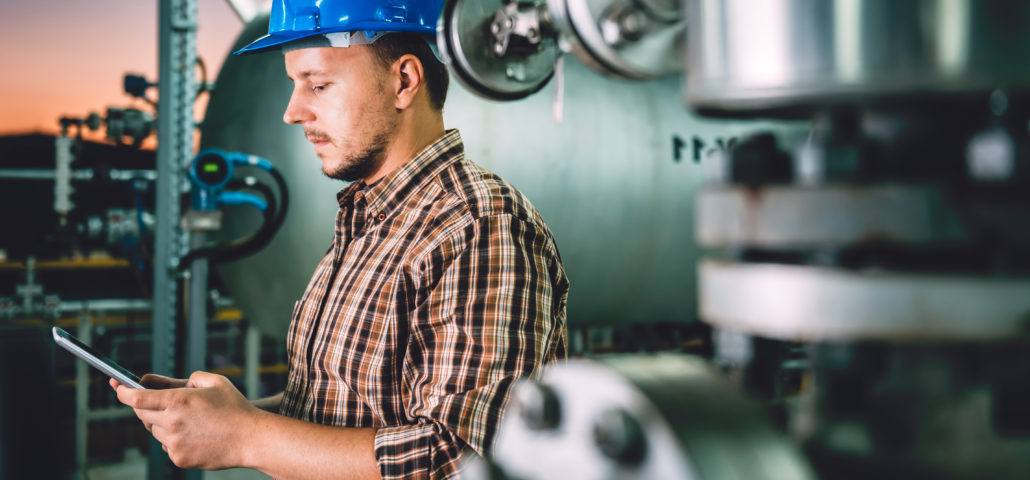 Man using tablet at Natural gas processing facility stockout